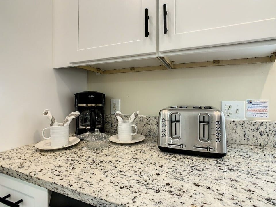 Start your day right with a cozy corner featuring a modern coffee maker and four-slice toaster. Conveniently located near Disney, this vacation home is designed with comfort and functionality in mind