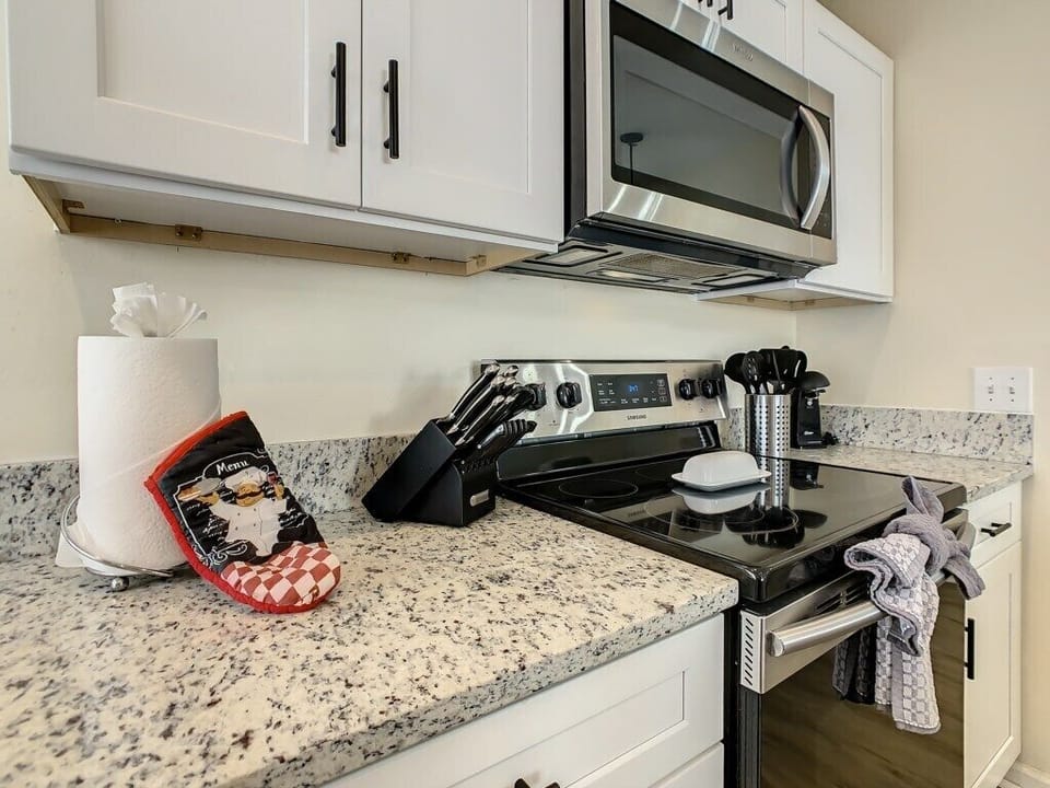 From the granite countertops to the well-stocked utensil drawer, this kitchen is made for cooking up comfort. Located near Disney in Orlando, Florida, this space is both practical and polished.