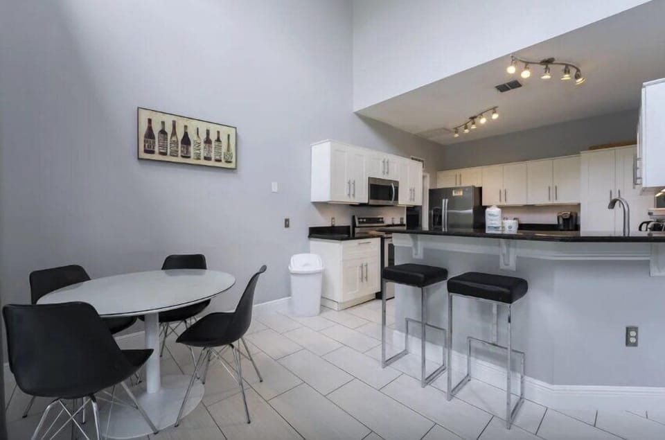 A well-lit breakfast nook with seating for four is a cozy yet functional space, perfect for enjoying meals with family or friends in a bright and welcoming environment.