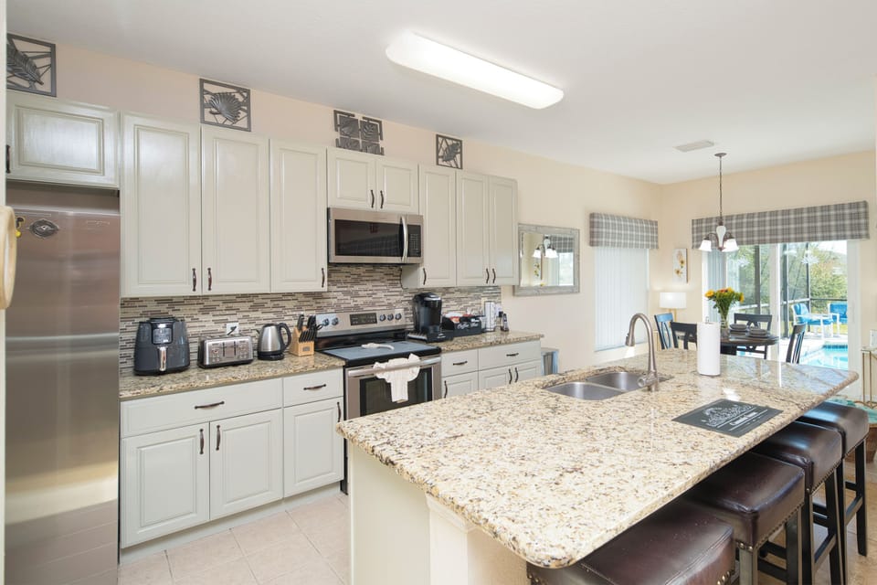 Spacious kitchen with stainless steel appliances, granite countertops, and all the cookware and utensils you need for family meals.