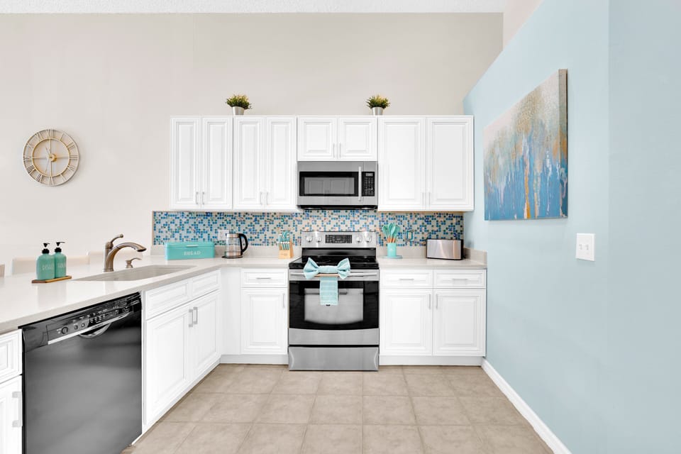 Bright kitchen with blue accents in Emerald Island Resort's 4 bed villa close to Disney World.