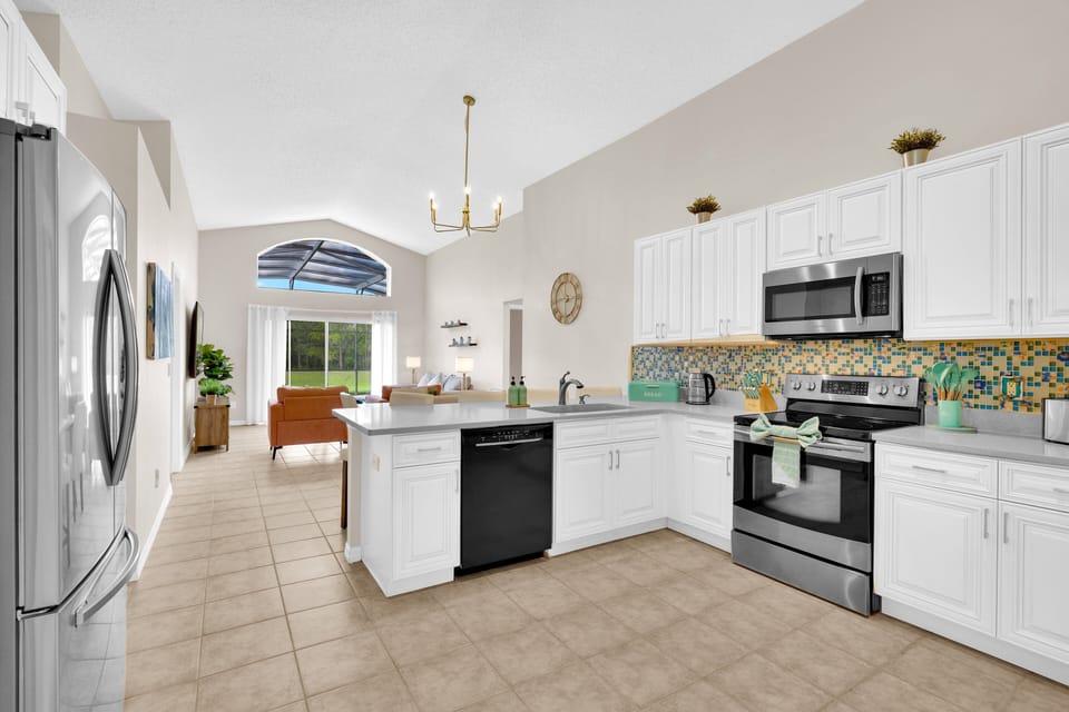 Fully equipped kitchen in 4 bed Emerald Island villa, overlooking lounge with peaceful resort views near Disney.