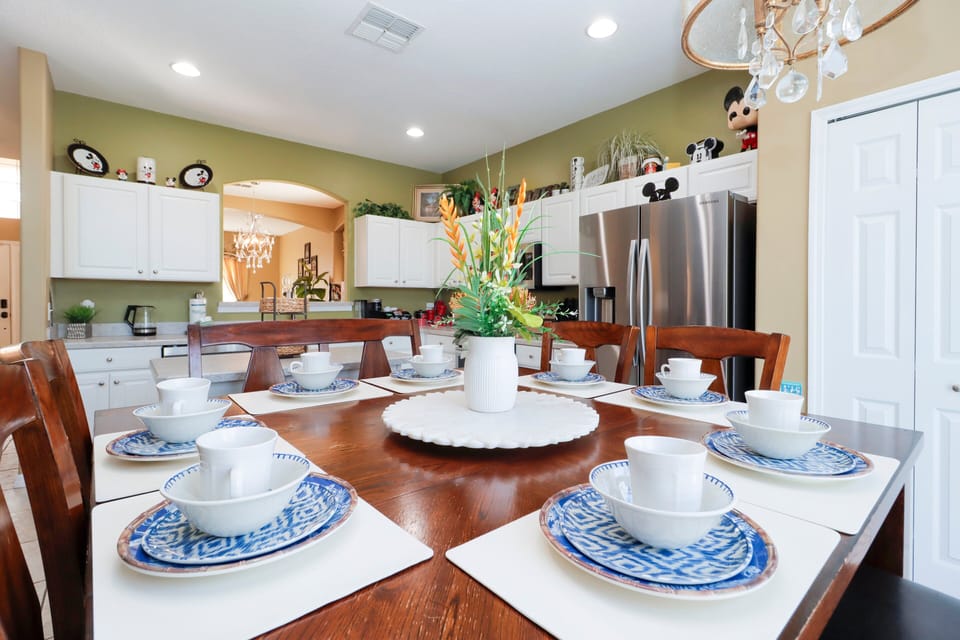 Gather around the large dining table that seats the whole group in comfort. The setting is ideal for family meals, celebrations, or casual breakfasts before hitting the parks.