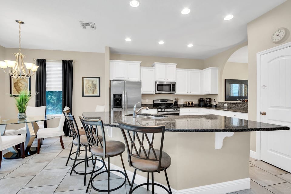 This bright, open, and modern kitchen is perfect for whipping up delicious Disney waffles before heading out for a day of adventure! With plenty of space and natural light, it's the heart of your vacation home.