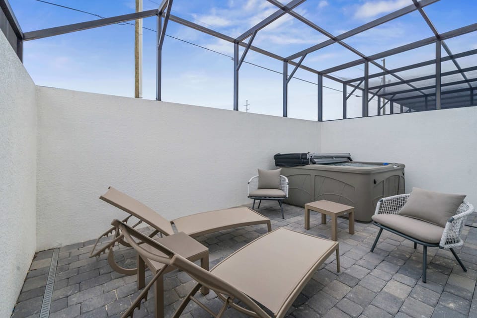 Relax and recharge in this private outdoor space featuring comfortable loungers and a hot tub - Perfect for sunbathing by day or stargazing by night, all in a peaceful setting - A serene retreat to create lasting memories with family and friends