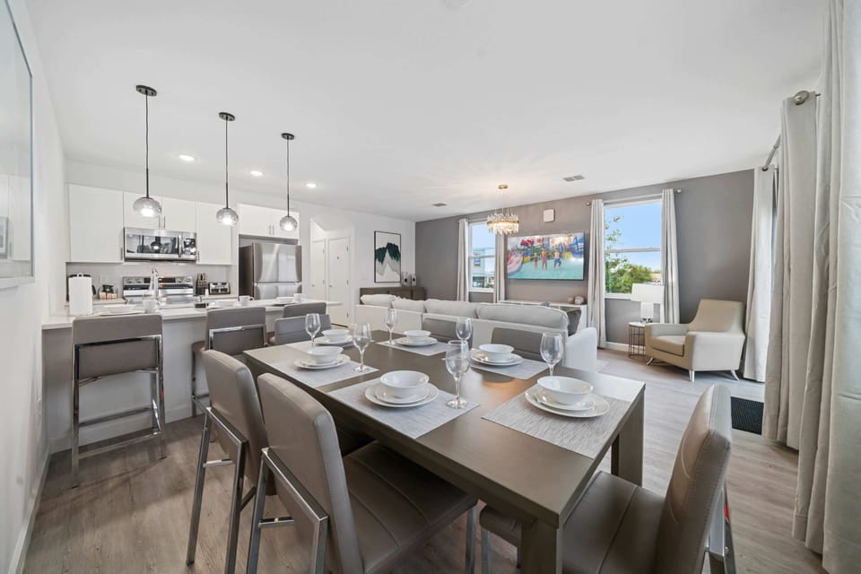 Savor meals together in the elegant dining area, with seating for all your guests - Fully equipped kitchen & island bar offer everything you need for cooking & mingling - Bright, inviting, and spacious ideal for shared moments and memorable meals