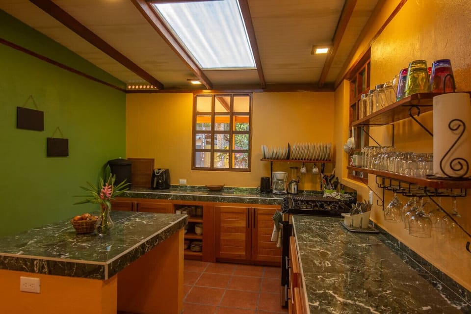 Bright kitchen area with central island in Playa Chiquita, Casa Rakú