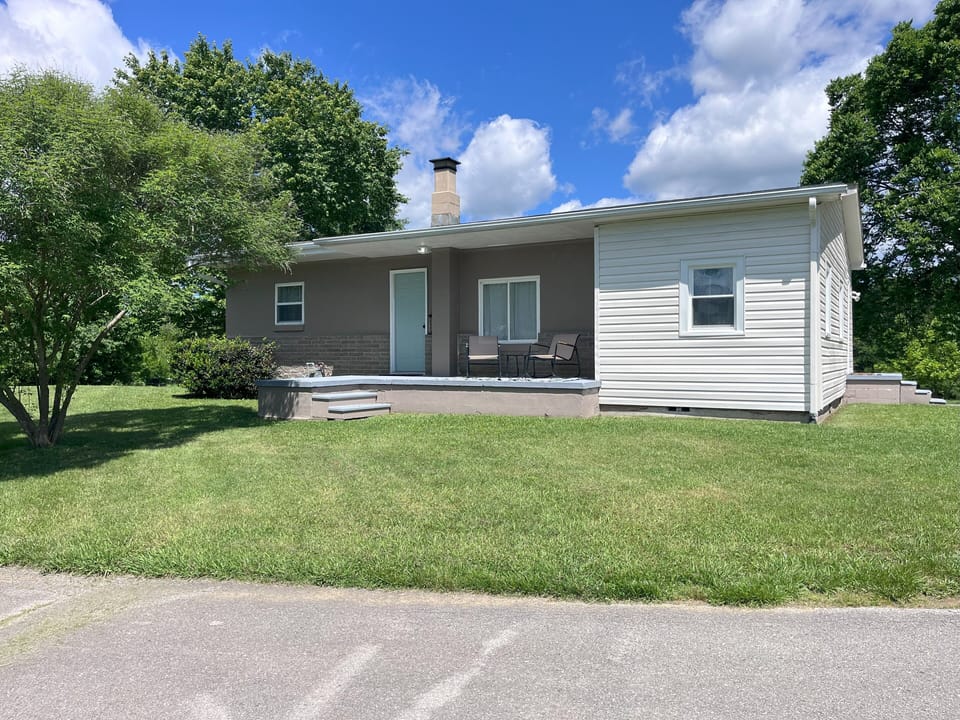 Front of the property, with a nice sitting area to relax on the front porch.