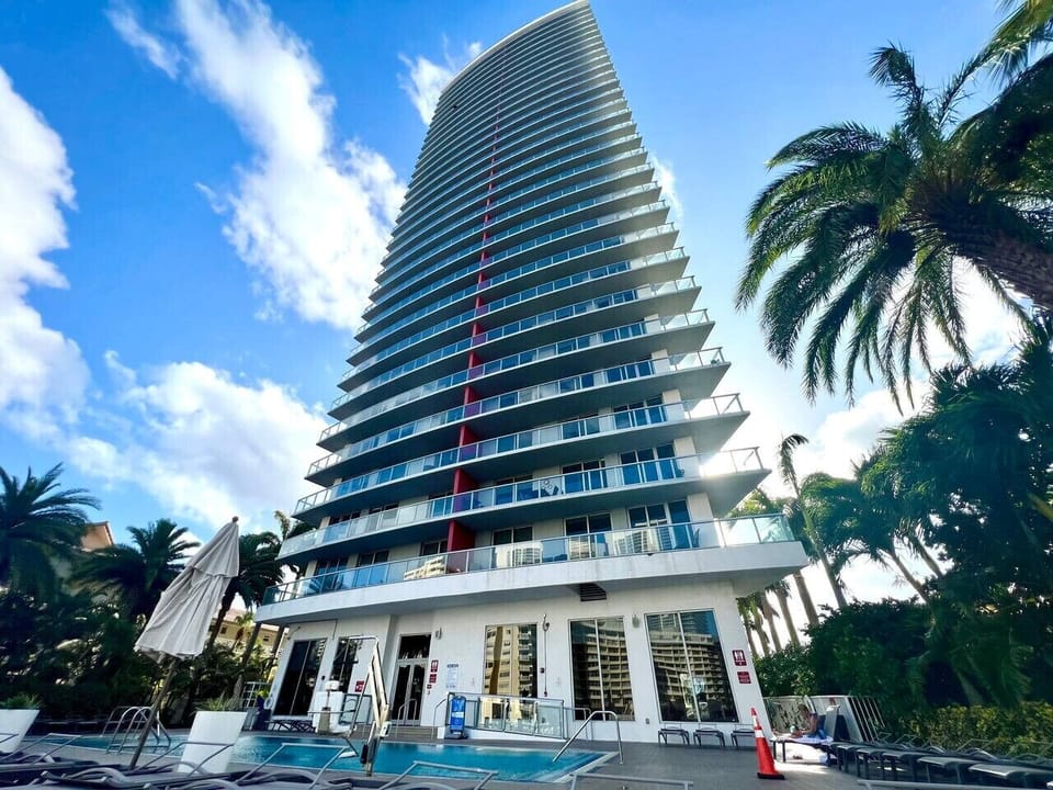 Outdoor pool surrounded by high-rises and cityscape views.