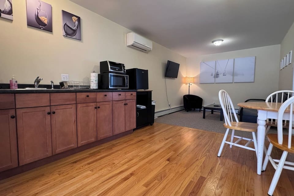 Open concept with Kitchenette, Living room, and dining area with both bedrooms and bathrooms off of the space