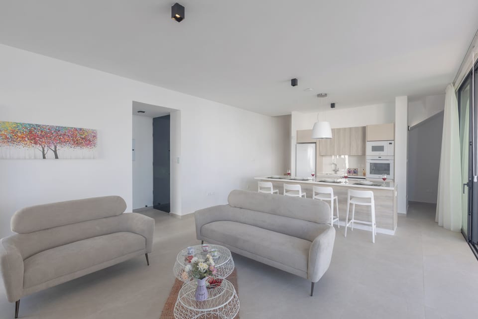 Living room with comfortable sofas, coffee table and Smart TV