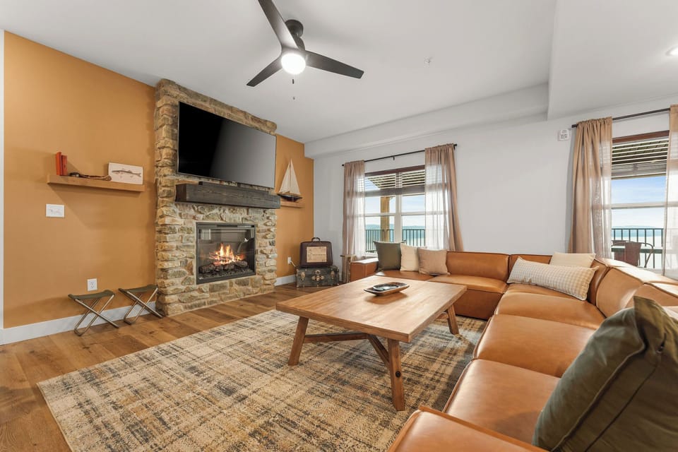 - Lounge in style by the glowing stone fireplace with a warm drink in hand
- Sink into the buttery soft leather sectional after a lake day adventure
- Watch sunsets dance through the large windows as you unwind in pure comfort