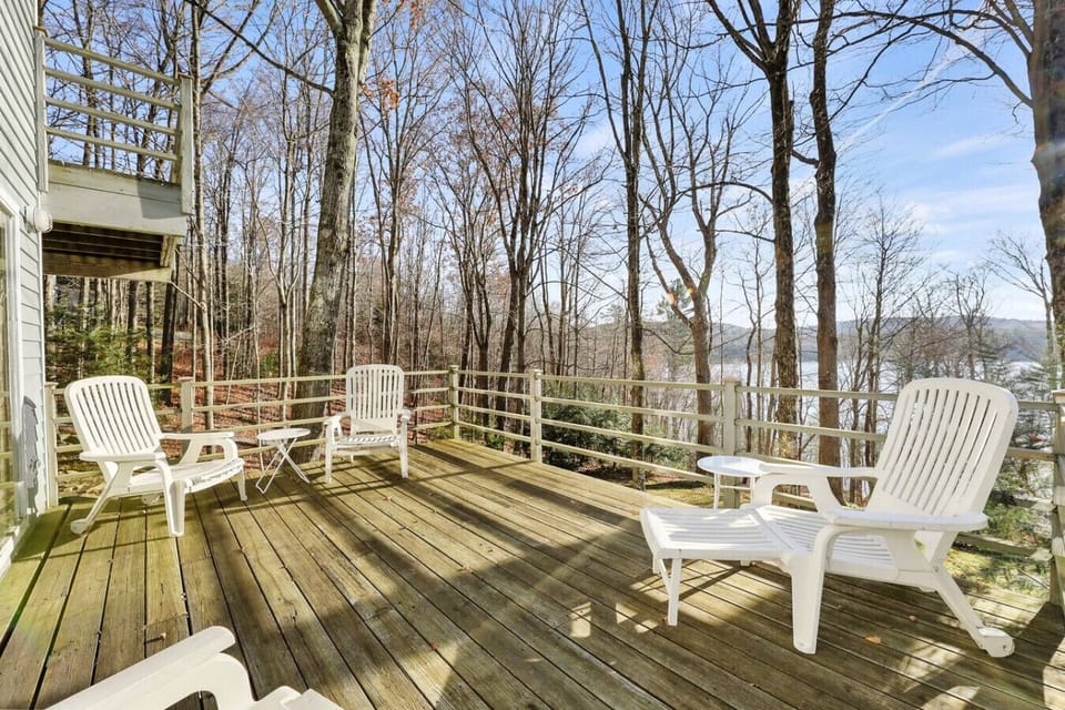 Elevated deck with patio chairs surrounded by peaceful woods ideal for morning coffee or evening chats.