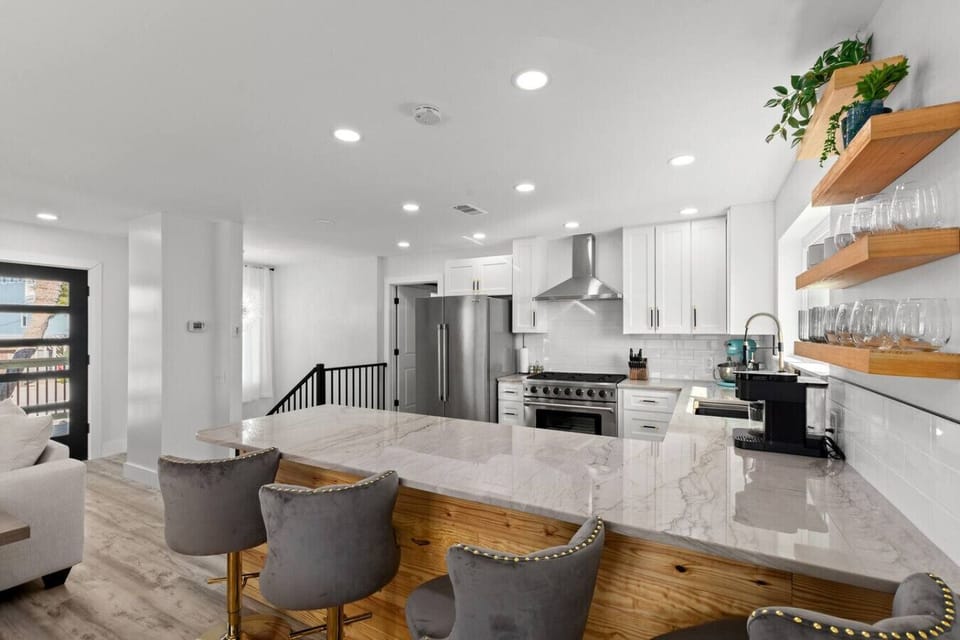 The centrally located, updated open kitchen with a breakfast bar, stainless steel appliances, and plenty of natural light is the perfect hub for family gatherings.