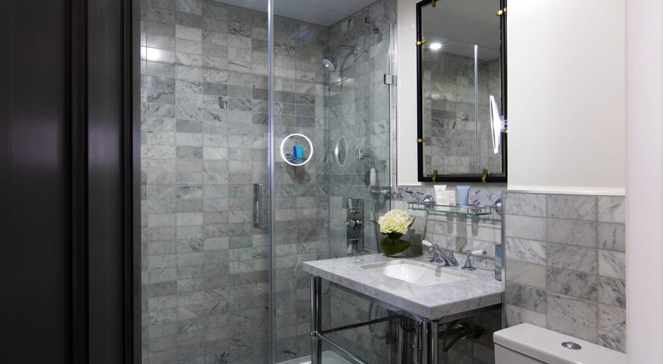 Shower, designer toiletries, hair dryer, bathrobes