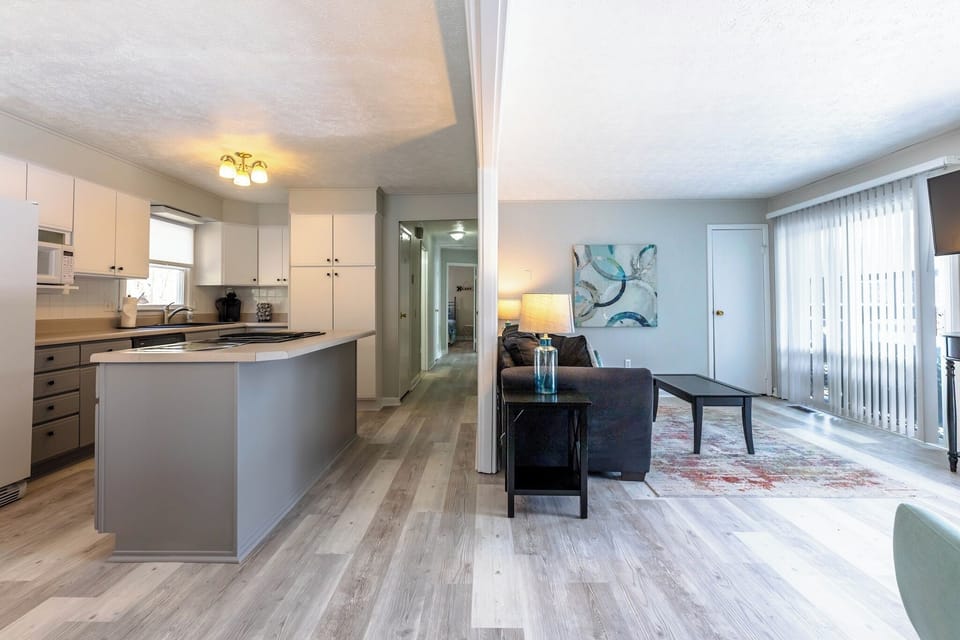 Bright open-concept space with a modern kitchen and cozy living area, perfect for relaxing or entertaining