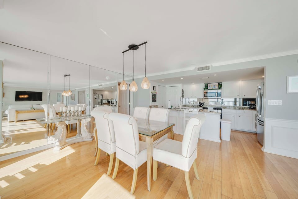 There is a dining table, perfect for enjoying a meal or playing a game, as well as additional breakfast bar seating.