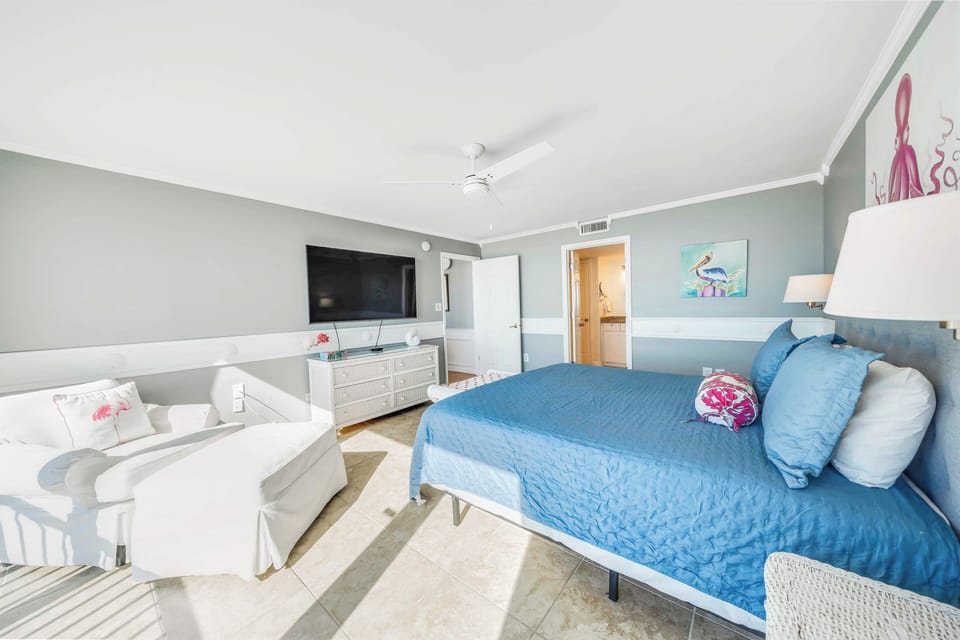 The master bedroom offers a King-sized bed, large television, gulf views, spacious walk-in closet, and its own ensuite bathroom.
