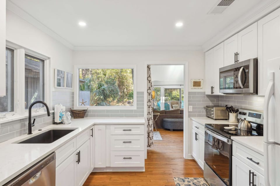 The airy kitchen offers ample space & all the comforts of home