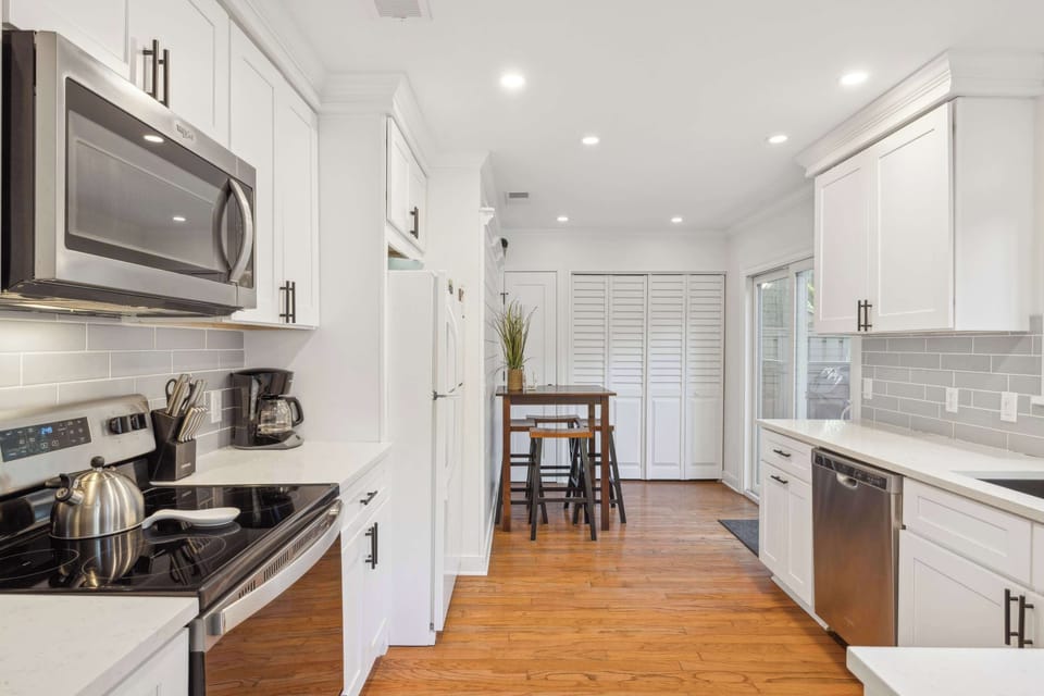 The airy kitchen offers ample space & all the comforts of home