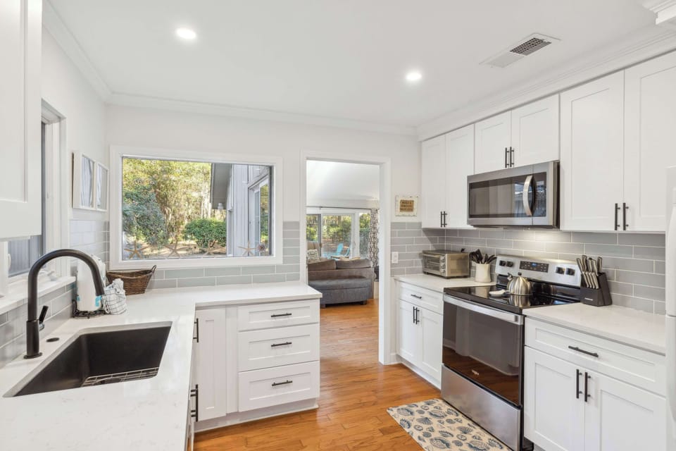 The airy kitchen offers ample space & all the comforts of home