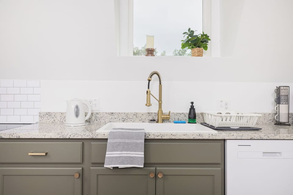 Large sink w/ dish soap & sponge. Electric kettle for teas & other things.