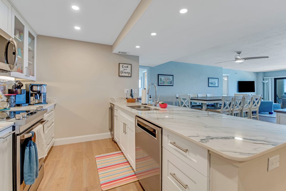 A well-furnished kitchen with many new appliances.