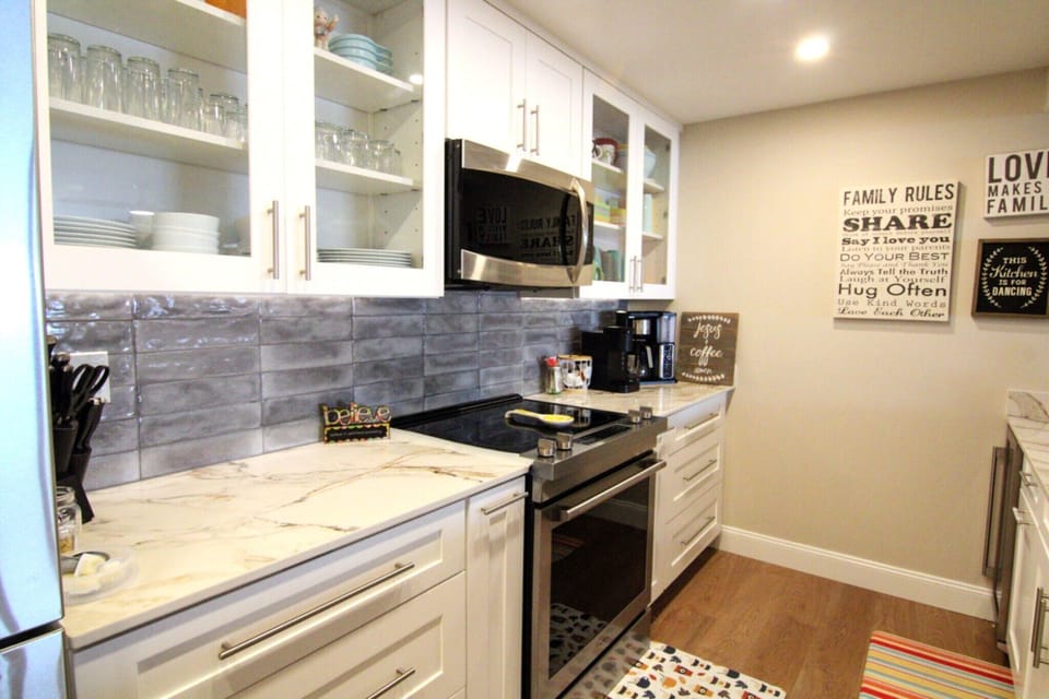 The kitchen with many new appliances and a coffee station