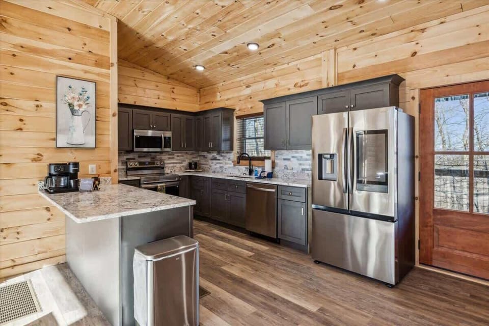  Modern appliances and elegant granite invite culinary adventures amidst rustic charm!