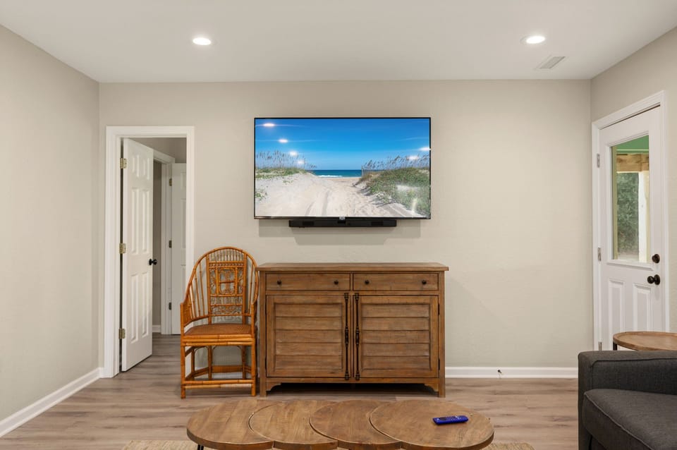 Cozy entertainment area with a large TV and rustic furnishings for a relaxing vibe.