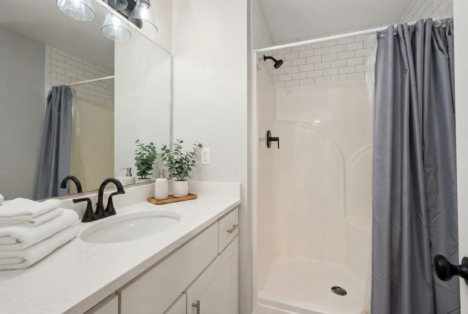 ML Bedroom 2 Bath - Modern and elegant bathroom with a sleek vanity and walk-in shower.