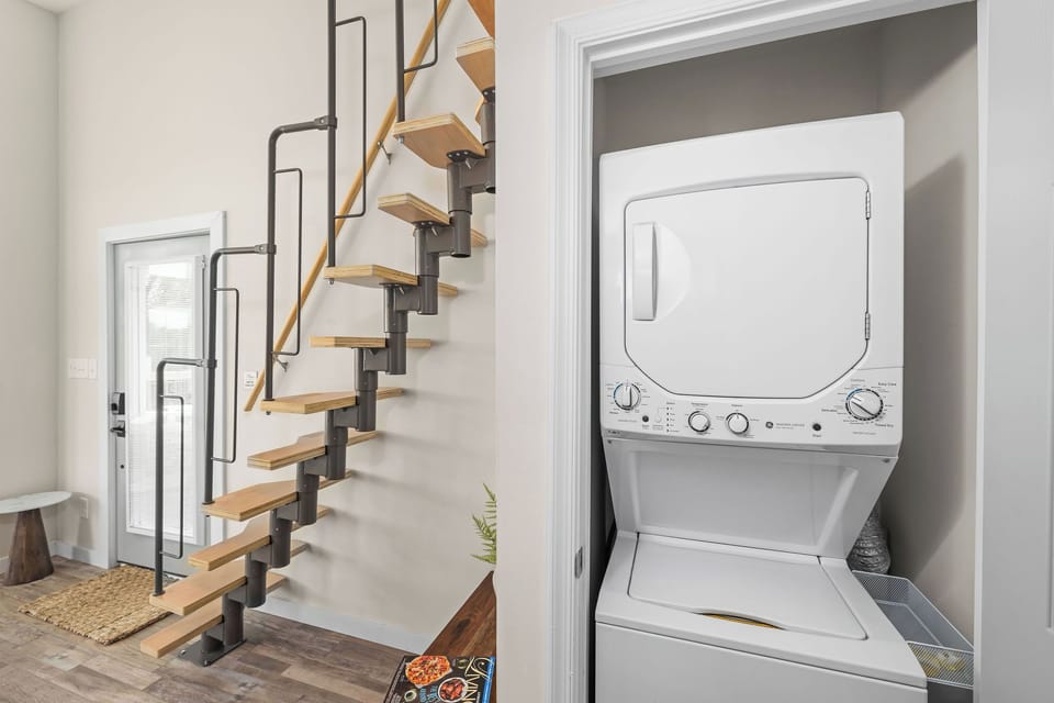 Washer and dryer are located under the stairs