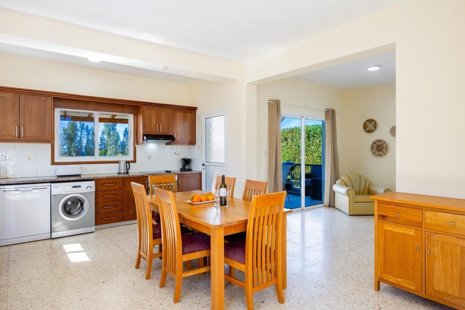 Open-plan living room with sofa, dining area, kitchen, WiFi internet, and satellite TV