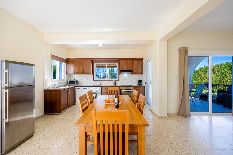 Open-plan living room with sofa, dining area, kitchen, WiFi internet, and satellite TV