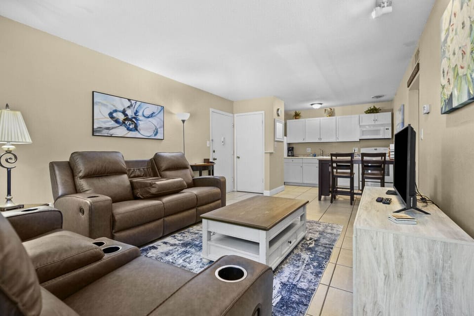 Reclining leather couches (so comfortable) with open plan space