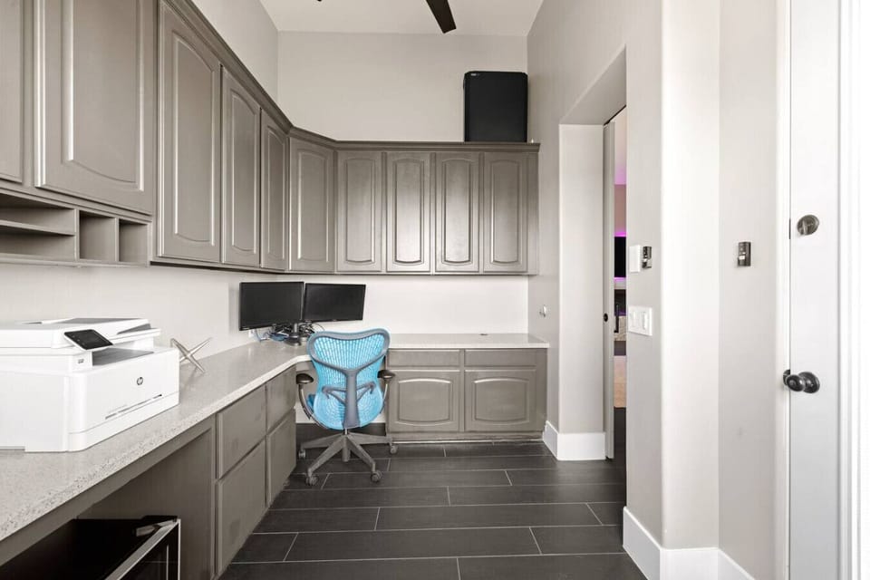 Dedicated office space with modern workstation setup, including monitor and printer- Access from the primary bedroom and connect to a private balcony