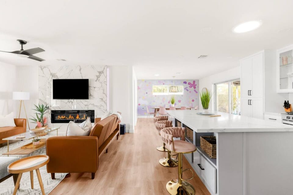 Newly renovated with an open floor plan, this home is perfect for hosting. Gather around the spacious kitchen island while enjoying the cozy glow of the living room fireplace.