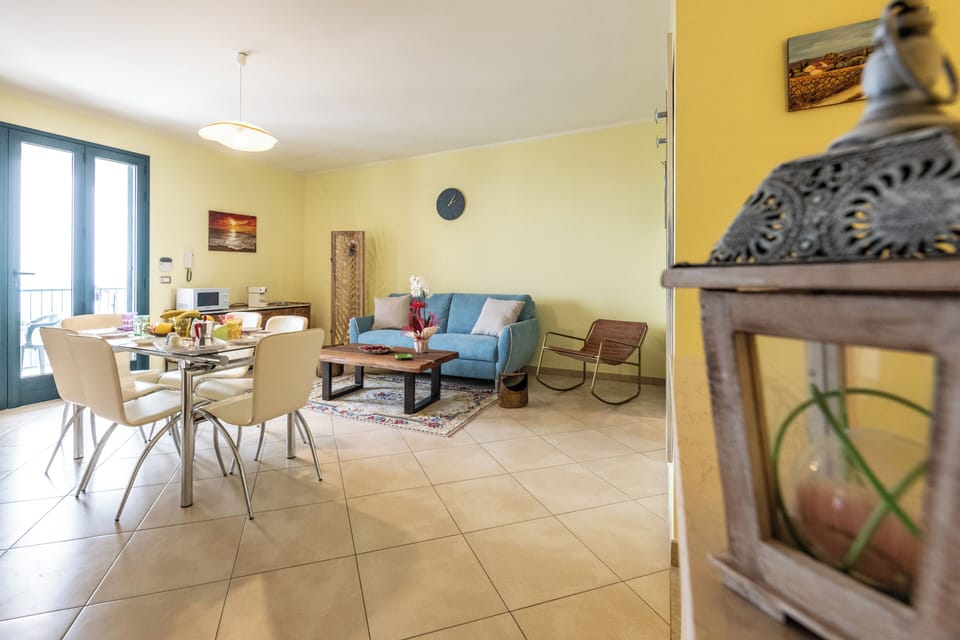 Apartment, Sea View | Living area | 32-inch TV with cable channels