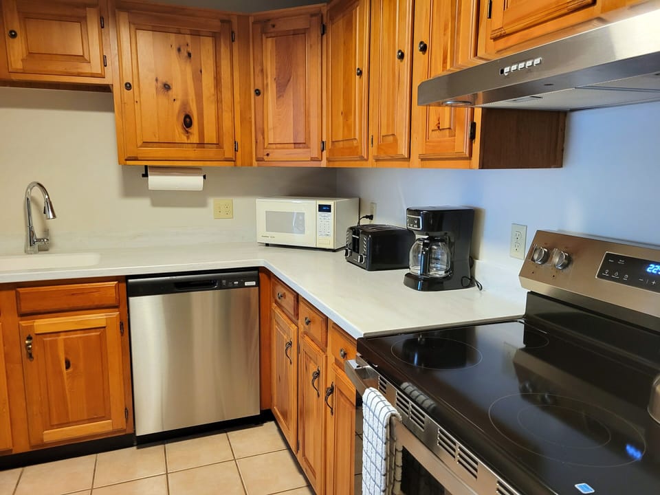 Kitchen has full size appliances, and is stocked with dishware, flatware, glassware, cooking utensils and pots & pans.