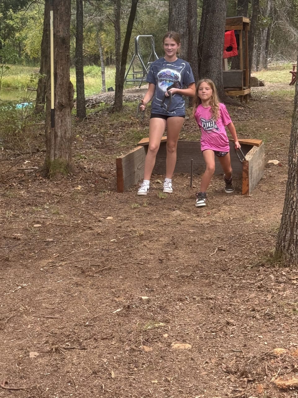 A couple of the grands enjoying a game of horseshoes 