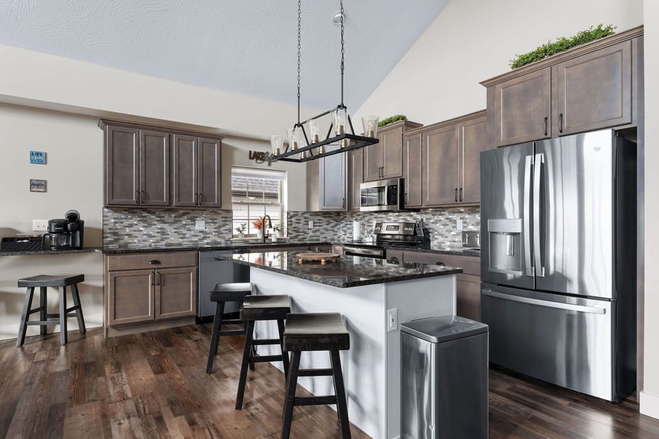 - Sleek kitchen featuring stainless steel appliances & granite countertops
- Spacious island with bar seating is perfect for breakfast, wine nights, or gathering around
- Everything you need is here, from a full coffee setup to plenty of prep space