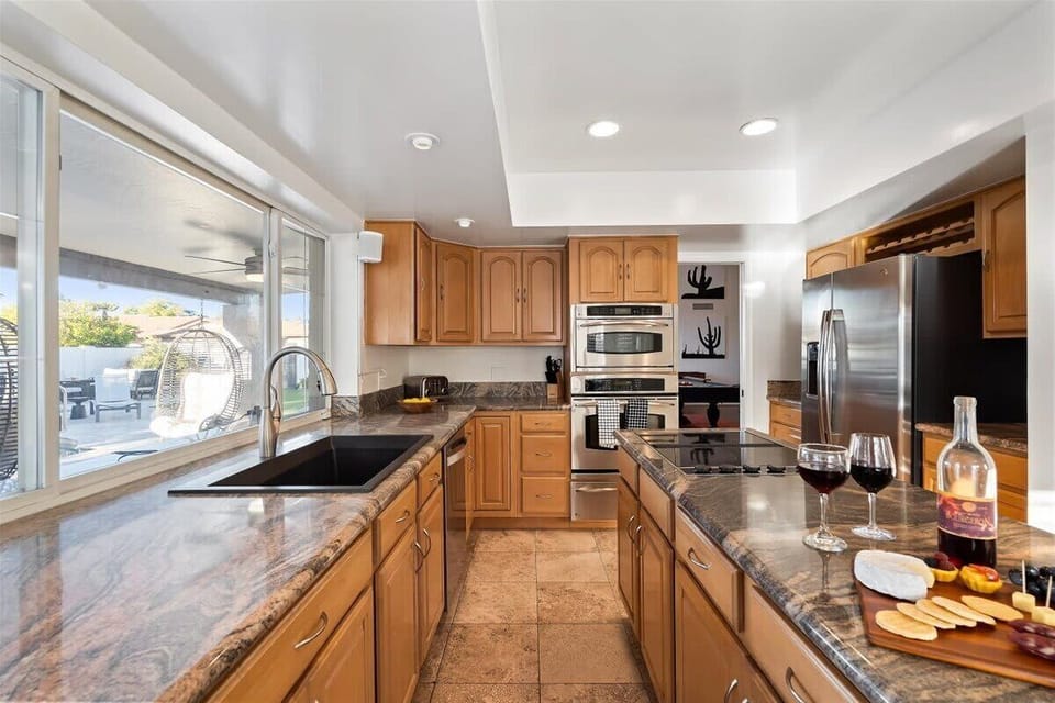 The fully equipped modern kitchen is stocked with all culinary essentials, stainless-steel appliances and dining area.