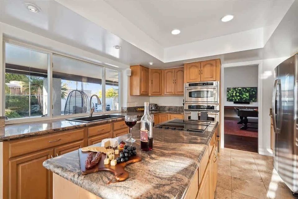 The fully equipped modern kitchen is stocked with all culinary essentials, stainless-steel appliances and dining area.