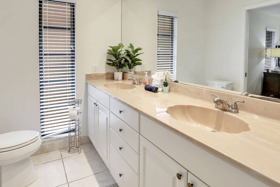 The primary ensuite bathroom includes dual sinks and lots of storage space.