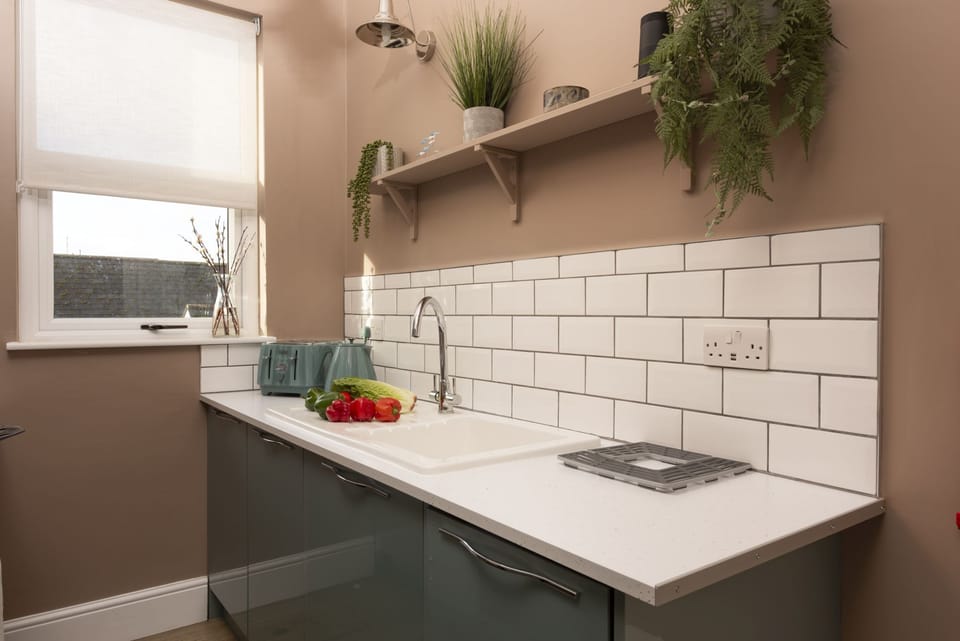 Sink unit with kettle and toaster.