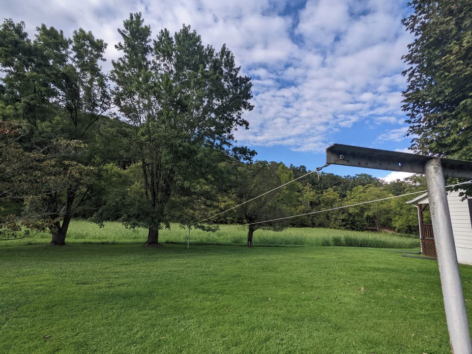 Wide-open space for relaxation or play, complete with a clothesline and scenic views.