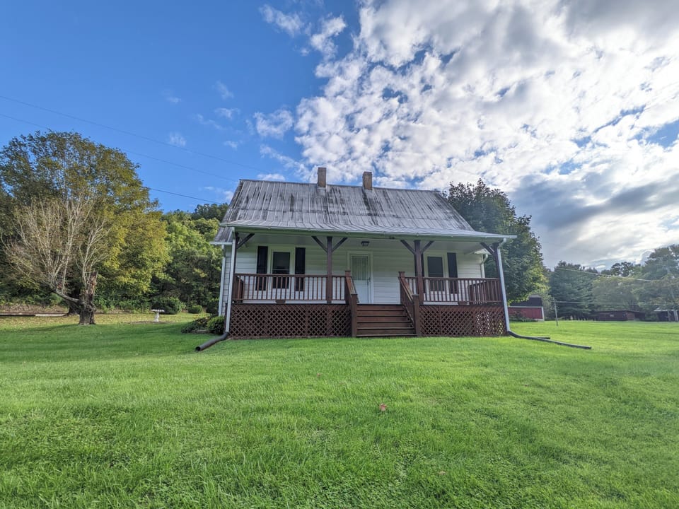 Relax on the charming porch of this countryside retreat surrounded by greenery.