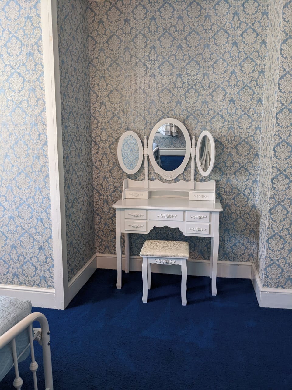  A lovely vintage-style vanity adds character and functionality to the room.
