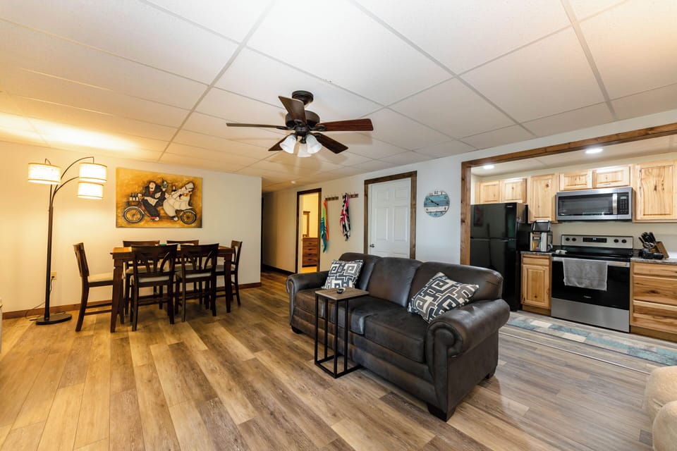 Spacious open-concept living and dining area with modern furnishings and a fully equipped kitchen.