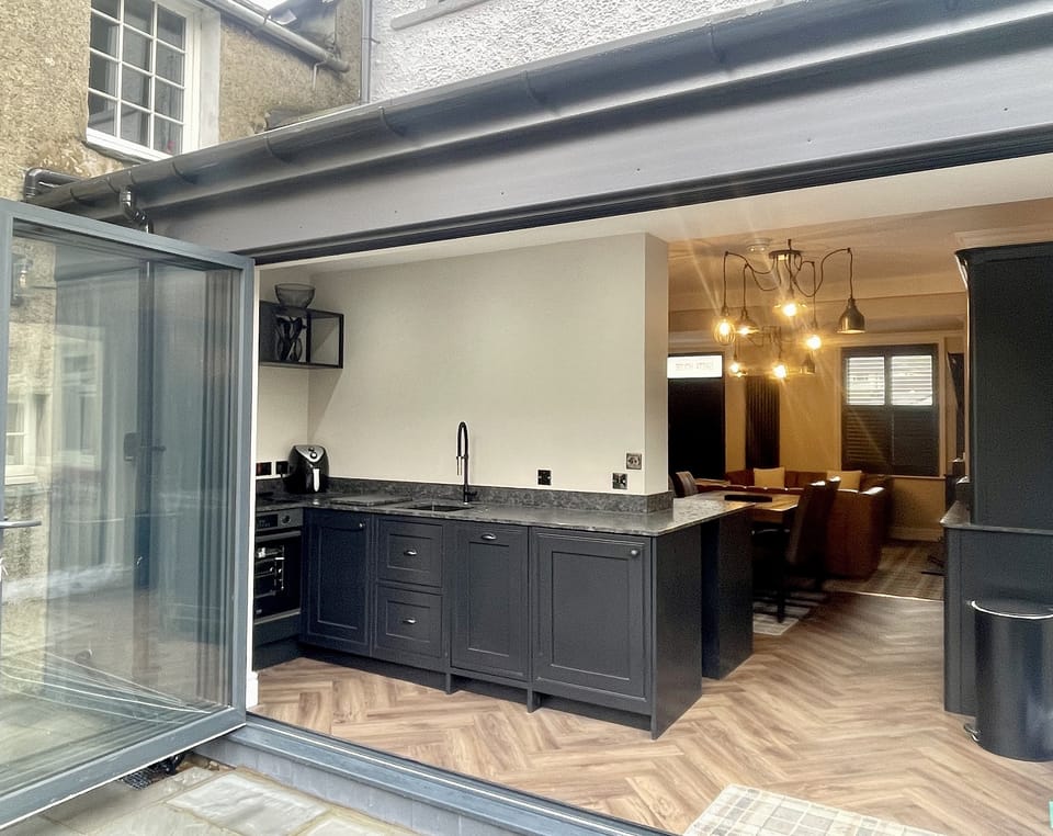 The kitchen is filled with light thanks to the bi-fold doors that open out onto the delightful patio area